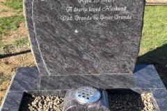 Dark granite kerbed memorial with white stone base — Rest in Peace