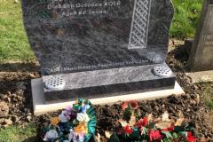 Traditional churchyard gravestone in cemetery setting