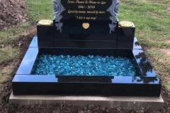 Black granite kerbed memorial marker with turquoise stone fill