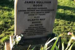 Light-coloured sandstone headstone — James Sullivan, loving father and grandfather