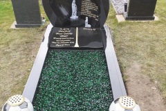 Black granite headstone with engraved inscription