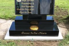 Black granite headstone with gold medallion — Forever In Our Hearts